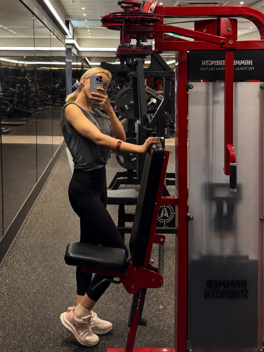 Bella taking a mirror photo during a gym visit.